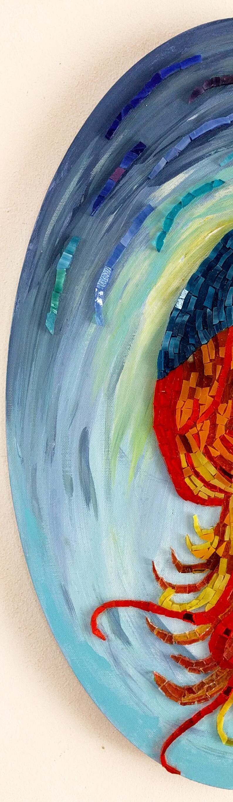 May include: A circular mosaic artwork featuring a stylized red, orange, and yellow jellyfish against a blue and green background.