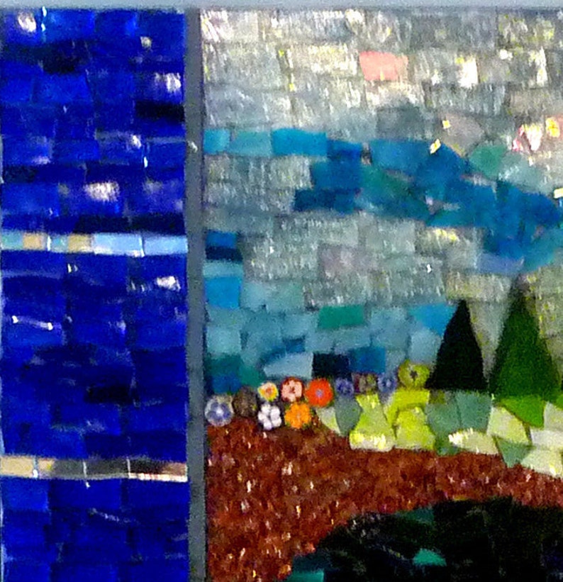 May include: A mosaic artwork depicting a landscape scene with a blue sky, green trees, and a brown ground with flowers. The artwork is made of small, colorful tiles.