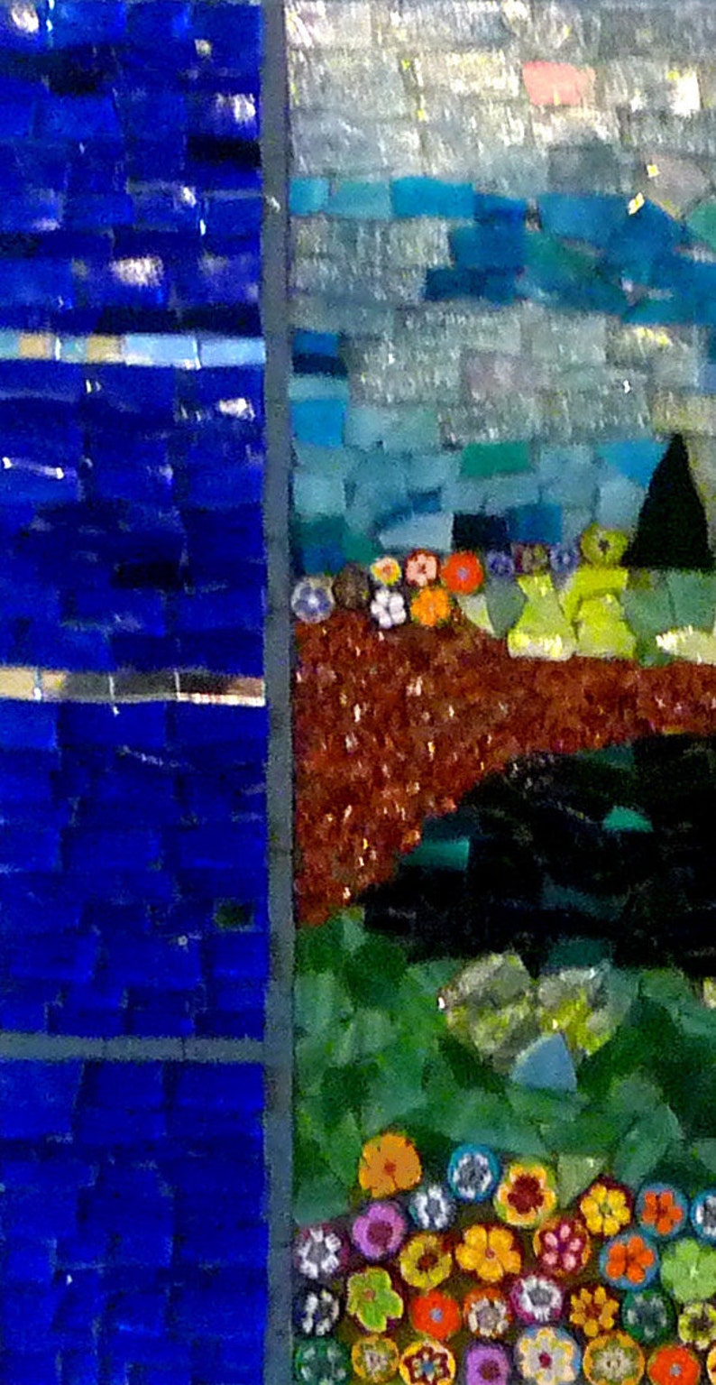 May include: A mosaic artwork featuring a blue sky, brown earth, green grass, and a cluster of colorful flowers. The artwork is made up of small, square tiles.