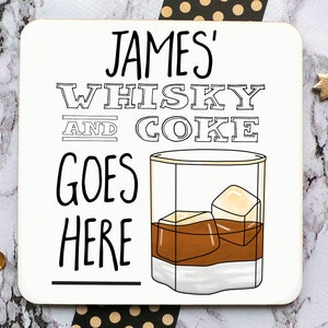 May include: White coaster with black text that reads "JAMES' WHISKY AND COKE GOES HERE" with a black and white illustration of a glass of whiskey with ice cubes.