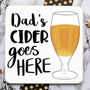 May include: White coaster with black text that reads "Dad's Cider goes HERE" and a cartoon illustration of a glass of cider.