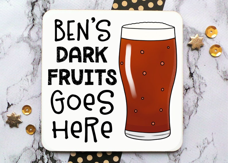 May include: White coaster with black text that reads "Ben's Dark Fruits Goes Here" and a cartoon illustration of a glass of dark beer.