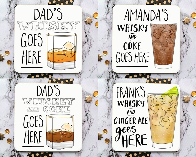 May include: Four white square coasters with black lettering and illustrations of glasses of whiskey and mixed drinks. The coasters say "Dad's Whiskey Goes Here", "Amanda's Whiskey and Coke Goes Here", "Dad's Whiskey and Coke Goes Here", and "Frank's Whiskey and Ginger Ale Goes Here".