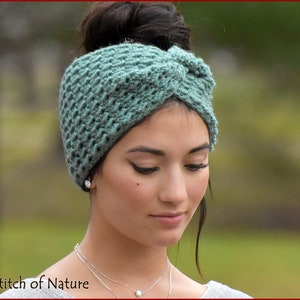 May include: A teal blue crocheted headband with a knotted design. The headband is worn by a person with dark hair.