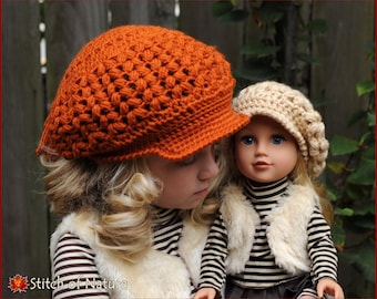 May include: A young girl wearing a brown crocheted hat with a doll wearing a beige crocheted hat. The girl is wearing a striped shirt and a white vest. The doll is wearing a striped shirt and a white fur vest.