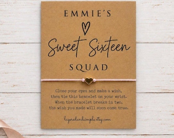 May include: A light pink string bracelet with a small gold-colored heart charm attached to a rectangular kraft paper card. The card features the black printed text EMMIE'S Sweet Sixteen SQUAD and instructions for a wish bracelet.