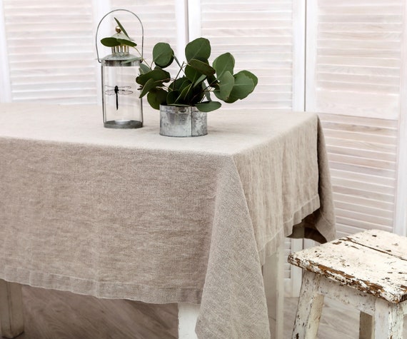 Washed linen tablecloth with decorative 1.5" edges and mitered corners. Table cloth in natural linen color. Available in 47 colors.