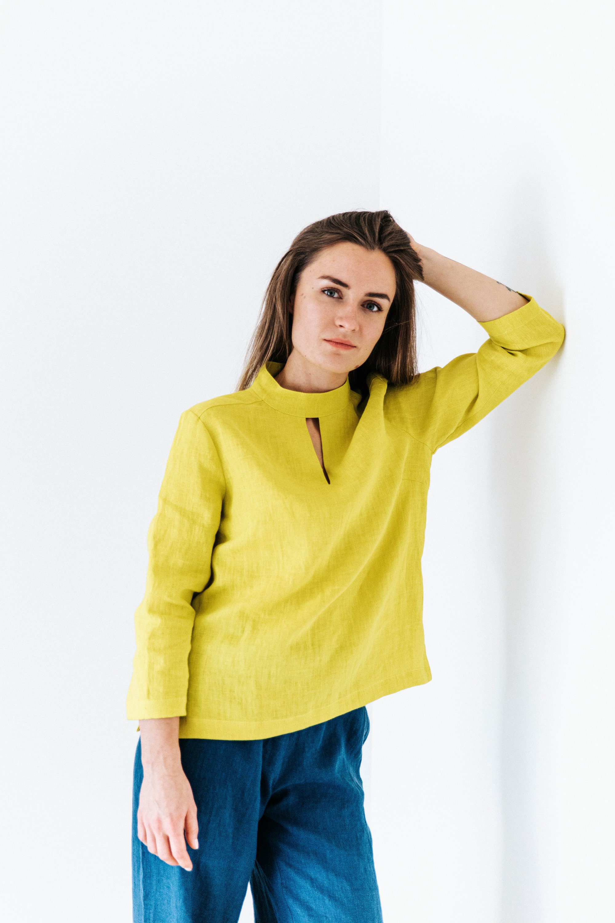Linen blouse with decorated neckline. Yellow color shirt. Elegant top