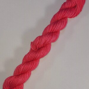 May include: A skein of bright pink yarn, perfect for knitting or crocheting.