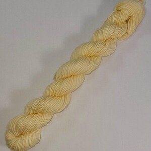 May include: A skein of pale yellow yarn, perfect for knitting or crocheting.