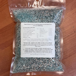 May include: A 2-pound bag of Peters Excel 15-5-15 Cal-Mag Special with Black Iron fertilizer. The bag is filled with small, colorful granules. The label lists the guaranteed analysis of the fertilizer, including nitrogen, phosphorus, potassium, and micronutrients. The label also includes directions for use and a list of plants for which the fertilizer is recommended.