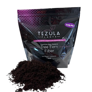 May include: A black bag with a pink and white logo that says "Tezula Plants" and "Grilly Mix". The bag contains a brown, shredded tree fern fiber. The bag says "Premium New Zealand Tree Fern Fiber" and "Sustainably Harvested 1 Gal".