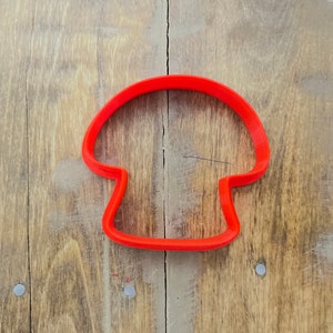 May include: Red plastic mushroom-shaped cookie cutter.