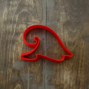 May include: Red plastic cookie cutter shaped like a Santa hat.