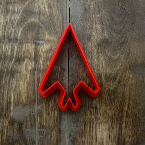 May include: Red plastic cookie cutter shaped like an airplane.