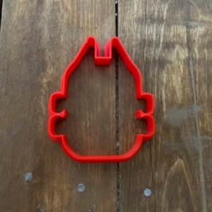 Puede incluir: Cortador de galletas de plástico rojo con forma de casa con chimenea y techo redondeado.