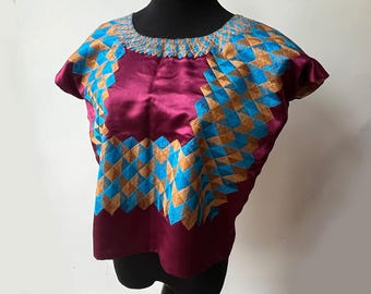Vintage 1985 Huipil from Tehuantepec, Oaxaca, beige and blue stitching on purple/maroon satin