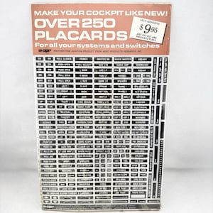 May include: A rectangular sheet of self-adhesive aviation placards featuring over 250 individual black labels with white text for cockpit systems and switches. The header reads MAKE YOUR COCKPIT LIKE NEW! OVER 250 PLACARDS. The sheet is tan and black.