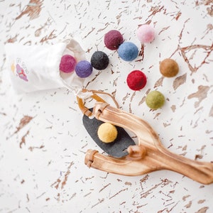 montessori inspired kids wooden sling shot with wool felt balls and muslin bag,  fun play outside busy toy