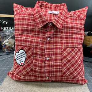 May include: A red and white plaid pillow with a heart-shaped patch that says "This is a gift I need to give whenever you hold me remember I am there. Love, Jimbo."