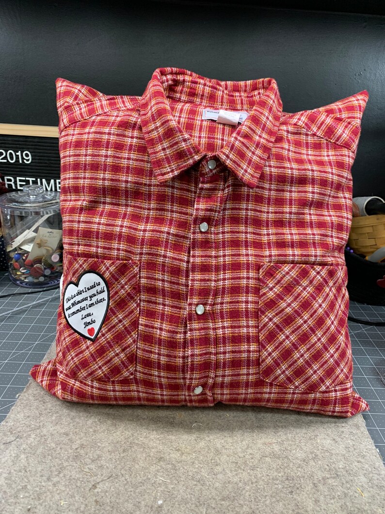 May include: A red and white plaid pillow with a heart-shaped patch that says "This is a gift I need to give whenever you hold me remember I am there. Love, Jimbo."