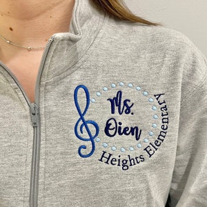 treble clef, custom personalized embroidery design, pullover quarter zip sweatshirt or full zip jacket with zippered pockets, hidden thumbholes, hooded hoodie, gray, black, royal blue, navy, teal, turquoise, pink, raspberry, coral, white, red