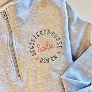 gray nurse sweatshirt with pink and blue design, multiple color options, black, blue, red, charcoal, green, purple, turquoise, teal, ciel