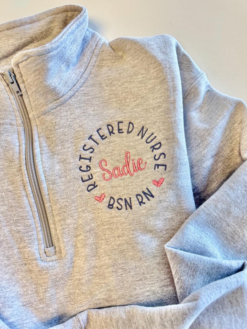 gray nurse sweatshirt with pink and blue design, multiple color options, black, blue, red, charcoal, green, purple, turquoise, teal, ciel