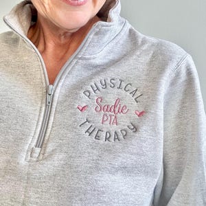 gift for physical therapist, PT, PTA, DPT, cute pullover sweatshirt, quarter zip, or full zip jacket with pockets, gray, dark gray, pink. cute but profession design, custom personalized, embroidered for long lasting quality, PT office, coworker,m