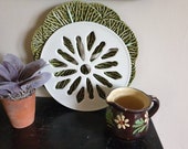 A pretty vintage ceramic pot stand trivet