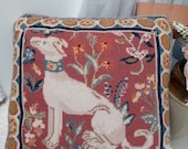 Vintage needlepoint cushion featuring a handsome lurcher surrounded by flowers with a pretty border, piped edge and navy blue backing.