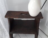 Antique wooden stepstool with cracket top and wide lower step shelf. Peg joints and heart shaped end supports. Deep rich patina and history