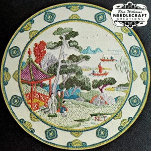May include: A circular embroidery piece featuring a landscape with a pagoda, trees, and figures. The scene includes boats on water and mountains in the background. The border has geometric patterns in teal and yellow. Text reads Elsa Williams NEEDLECRAFT CREATIONS.