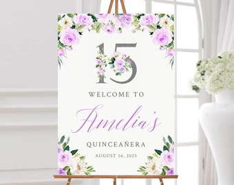 May include: A welcome sign for a quinceañera with a floral design in shades of purple and white. The sign features the number 15 in silver glitter, the name "Amelia's" in cursive script, and the text "Welcome to Amelia's Quinceañera August 16, 2025".