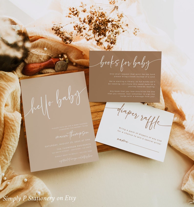 May include: Three cards for a baby shower. The first card is brown with white text that says "hello baby" and has the baby shower details. The second card is brown with white text that says "books for baby" and asks guests to bring a book instead of a card. The third card is white with brown text that says "diaper raffle" and asks guests to bring a pack of diapers for a chance to win a prize.