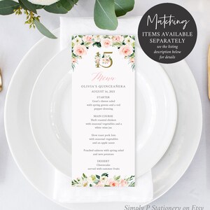 May include: A pink and green floral design menu card with the text "Menu" and "Olivia's Quincea&ntilde;era" with the date "August 16, 2021". The menu lists the starter, main course, and dessert for the event.