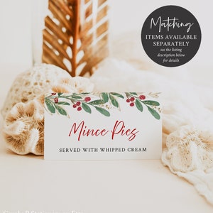 May include: A white rectangular card with the text "Mince Pies SERVED WITH WHIPPED CREAM" in red script. The card is decorated with a watercolor design of green leaves, red berries, and gold accents. A black circle with white text reads "Matching ITEMS AVAILABLE SEPARATELY see the listing description below for details."