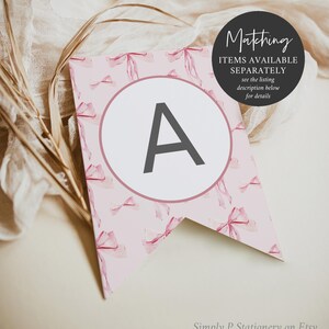 May include: A pink and white printable banner with a watercolor bow pattern. The banner has a large letter A in a circle. The text "Matching Items Available Separately" is on the banner. The text "See the listing description below for details" is on the banner. The text "Simply P Stationery on Etsy" is at the bottom of the banner.