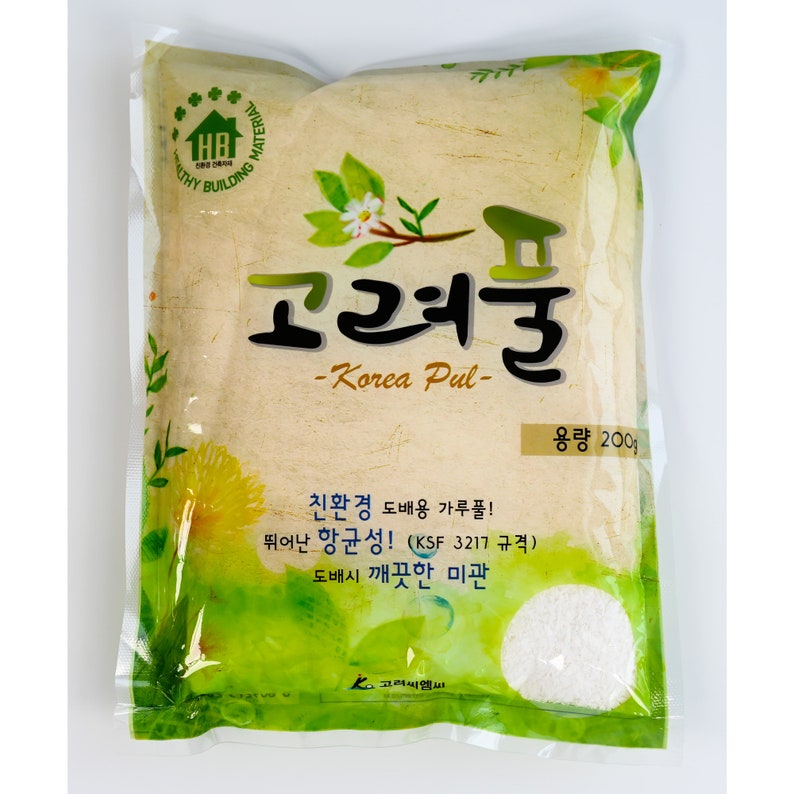 May include: A green and white bag of Korea Pul, a type of wallpaper paste, with the text "Korea Pul" and "용량 200g" (meaning "Capacity 200g"). The bag is labeled as environmentally friendly and has antibacterial properties.