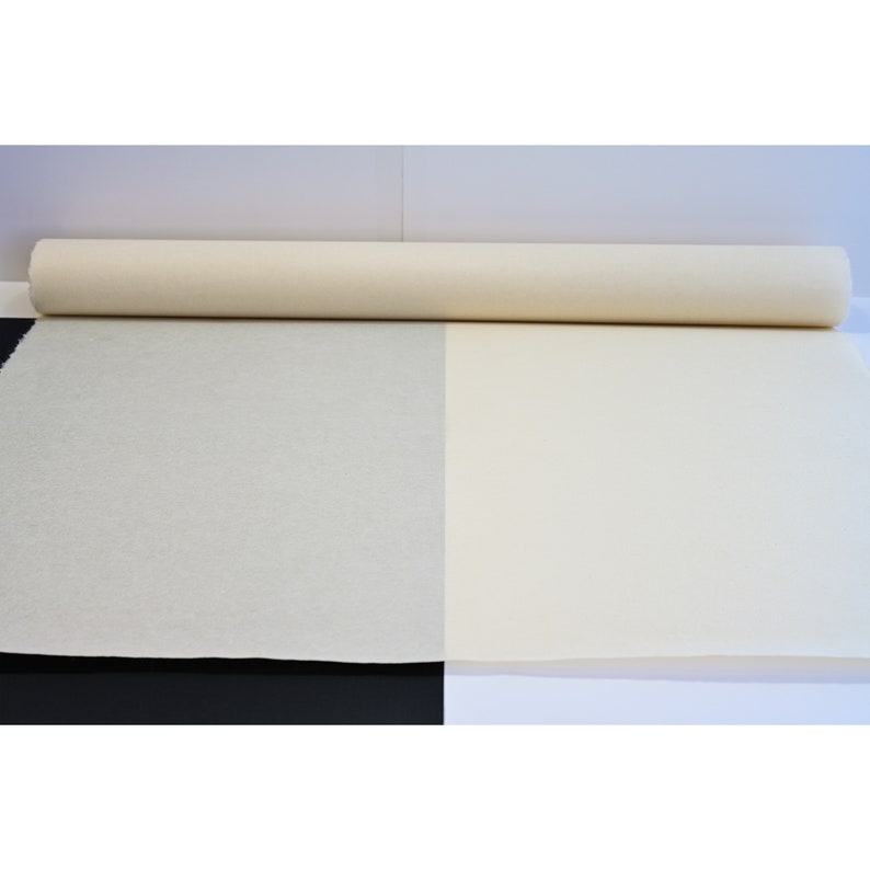 May include: A roll of white canvas fabric, unrolled to show the texture of the material.