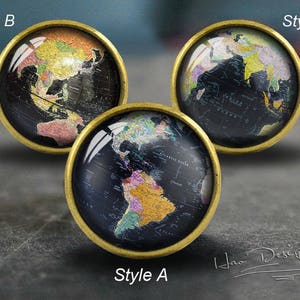 May include: Three round, gold-toned, decorative knobs with a black and gold world map design. The knobs are labelled "Style A", "Style B", and "Style C".