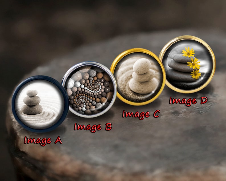 May include: Four round, decorative, metal,  cabochons with different images of stacked stones. The images are labeled "Image A", "Image B", "Image C", and "Image D".