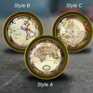 May include: Three antique-style round knobs with a gold finish and a vintage world map design. The maps are different styles, with one showing the world, one showing the Americas, and one showing the Arctic.