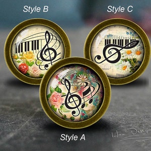 May include: Three round, gold-toned, decorative, glass cabochons with different designs featuring a treble clef and musical notes. The designs include a piano keyboard, floral patterns, and musical notes on a vintage sheet music background. The cabochons are labelled "Style A", "Style B", and "Style C".