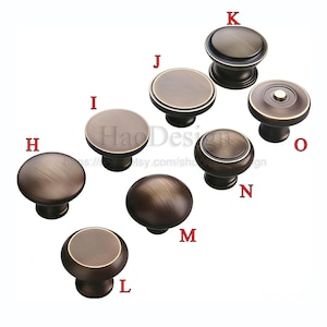 May include: A selection of bronze cabinet knobs in different styles. The knobs have a metallic finish and include round, flat, and domed shapes. Some knobs have a decorative edge or a raised centre. The image includes the text "HaoDesign".