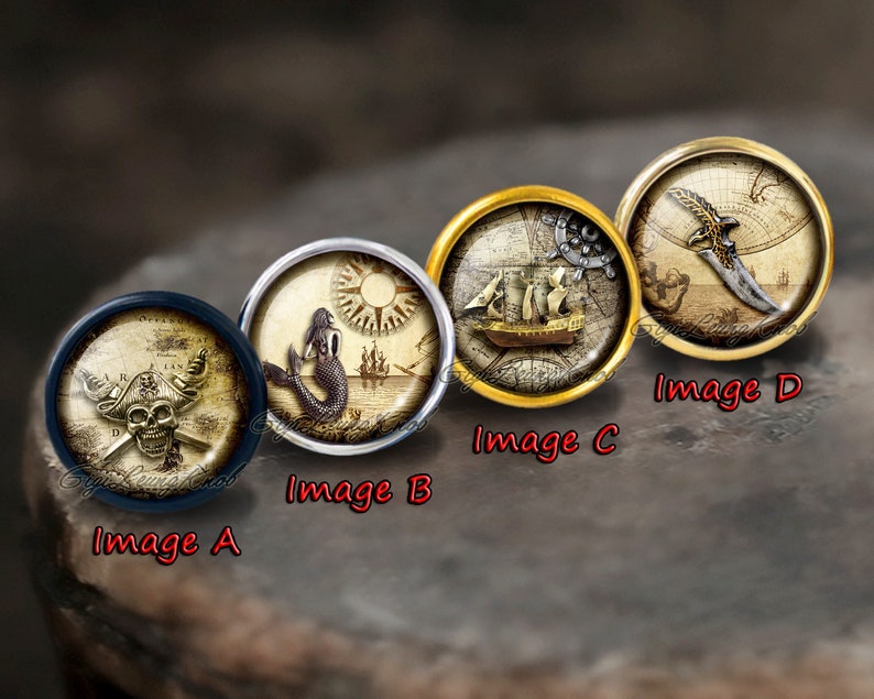 May include: Four round, decorative, glass cabochons with different nautical themes. The cabochons are set in metal frames. The first cabochon features a skull and crossbones with a pirate hat. The second cabochon features a mermaid with a compass and a ship in the background. The third cabochon features a ship with a compass and a map. The fourth cabochon features a dagger with a map in the background.