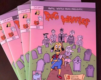 May include: A stack of five comic books with a pink cover and the title "Dog Waffles" in a dripping font. The cover features a cartoon dog with a yellow body, red ears, and a blue shirt holding an axe. The dog is walking on a path in a graveyard. The text "Awful Waffle Press Presents: Dog Waffles" is at the top of the cover. The text "5 Thrilling Waffle Dog Misadventures and So Much More!" is at the bottom of the cover.