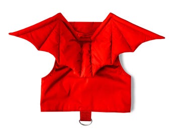 May include: Red dog harness with attached bat wings. The harness has a ring for attaching a leash.