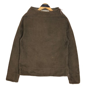 May include: A brown long-sleeved shirt with a high, rounded collar. The shirt has a simple design with a straight hem and a zipper detail on the side. The fabric appears to be a soft, textured material.