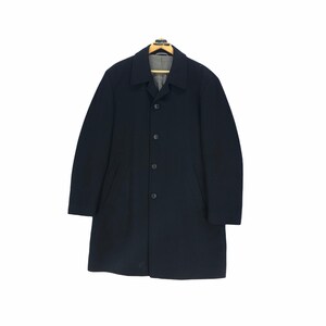 May include: A navy blue overcoat with a classic design. The coat features a button-up front, a notched collar, and two front pockets. It is hanging on a wooden hanger against a white background.